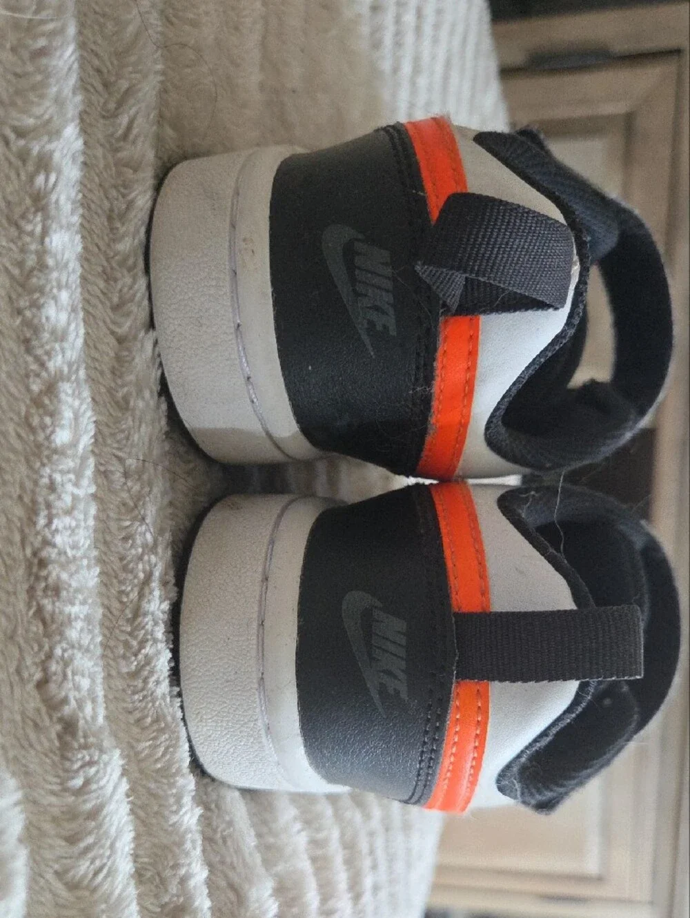 Nike Kids Low-Top Sneakers in White, Black & Orange Swoosh